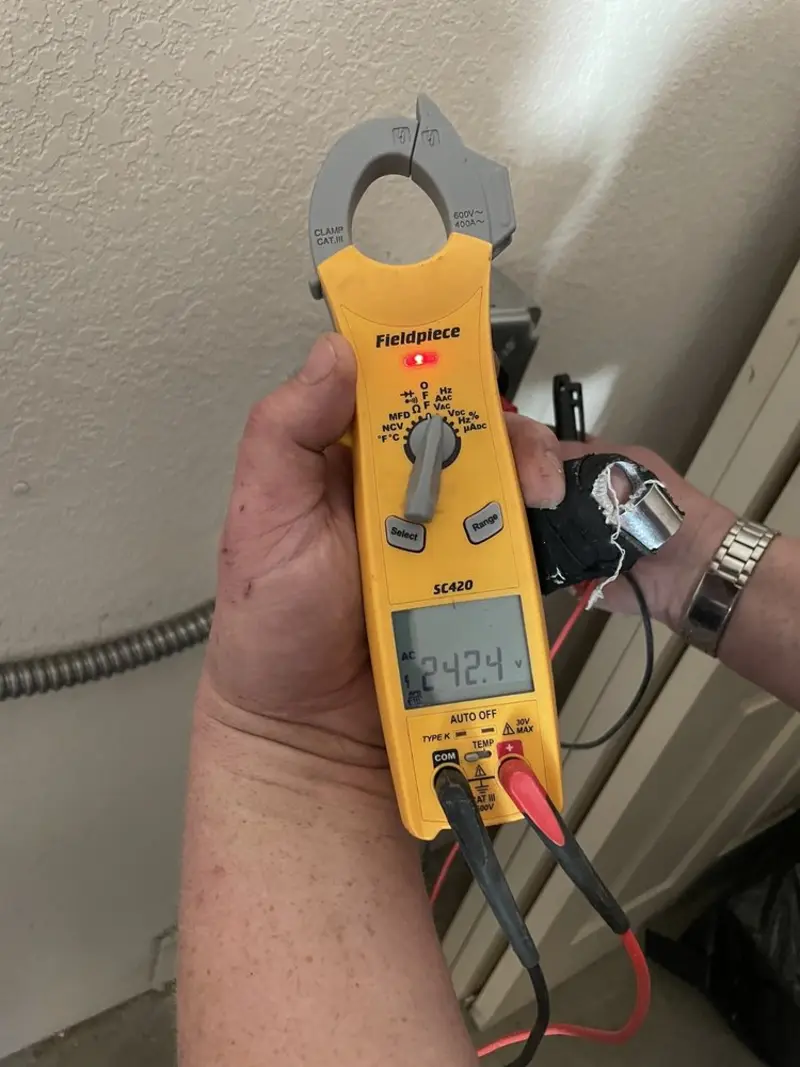 Voltage testing with clamp meter during Recessed Lighting Installation in Paola